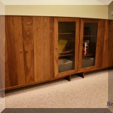 F18. 2 Wooden three-door cabinets. 49”h x 64”w x 16”d 